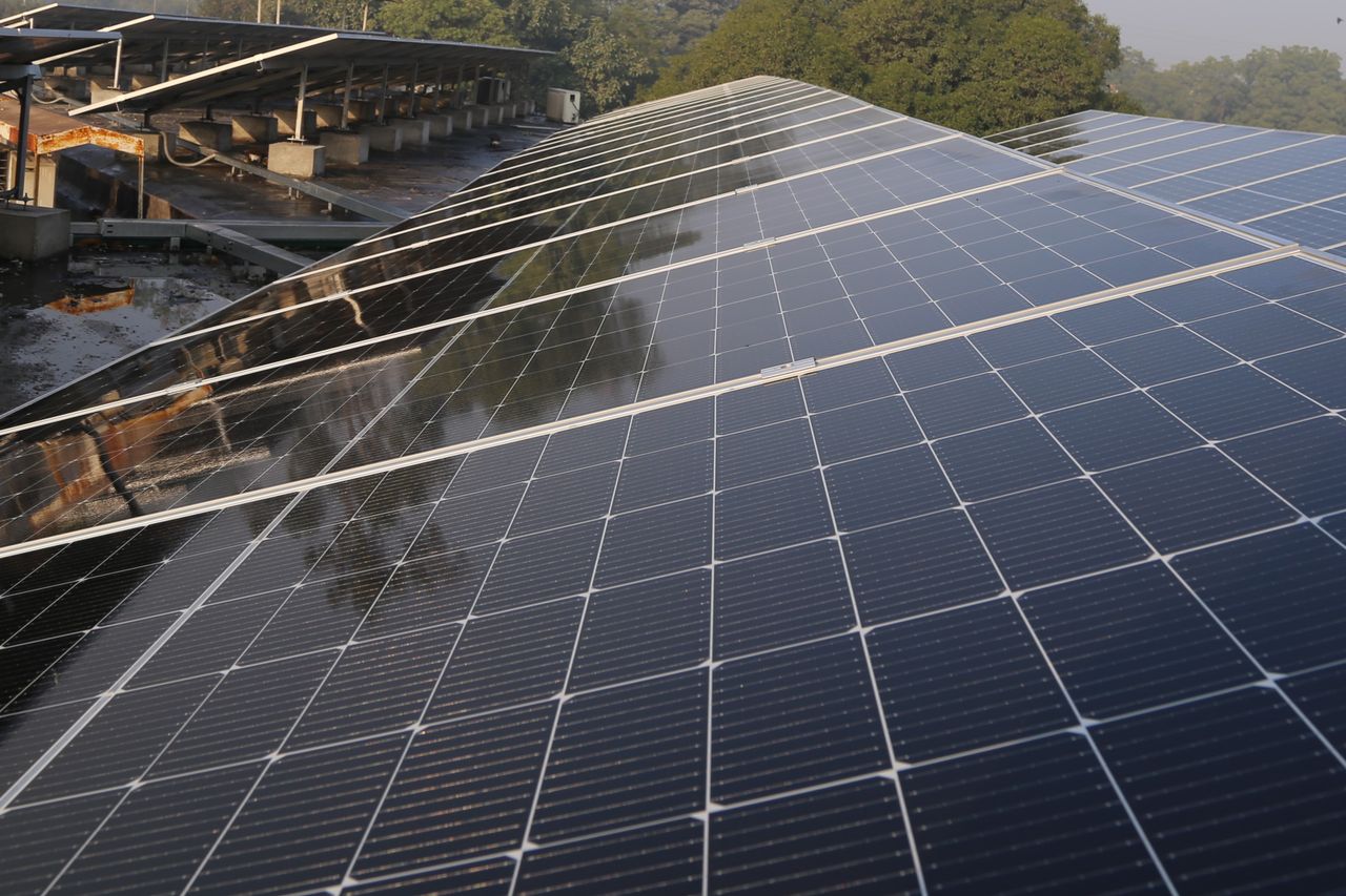 about-01 Wide view of solar panels on a rooftop in Lahore, promoting clean energy and sustainability.