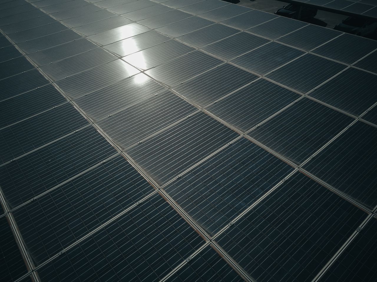 gallery-1 Captivating close-up of solar panels reflecting sunlight, showcasing renewable energy technology.